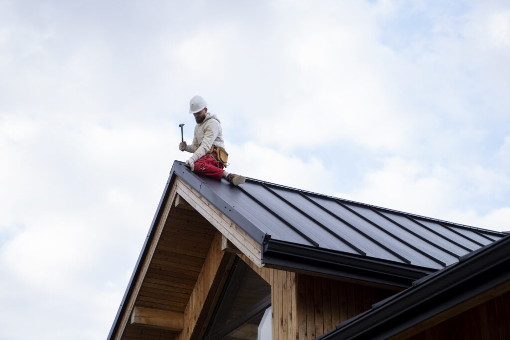 Contractor installing a metal roof